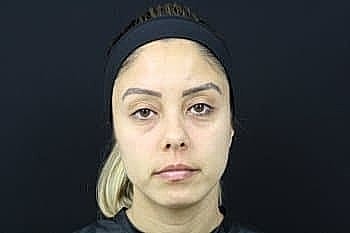 Woman with neutral expression and black headband.