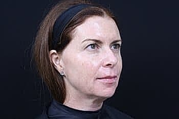Woman with long hair against dark background
