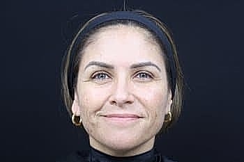 Smiling woman with medium-length hair and headband.