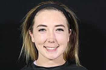 Smiling young woman with light brown hair.