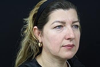 Profile portrait of a woman with long hair.