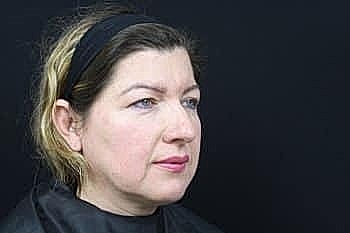 Woman with natural makeup against black background