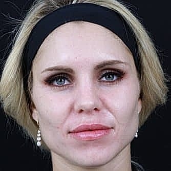 Woman with blonde hair and bold makeup.