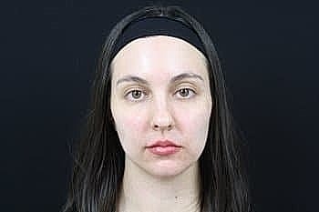 Woman with long hair against black background