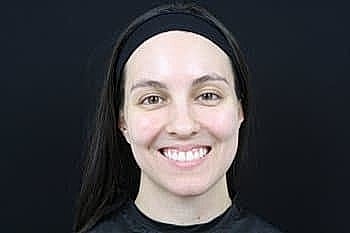 Smiling woman with long hair and headband.