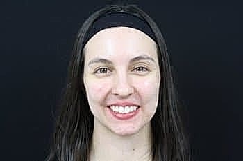 Smiling woman with long hair and headband.