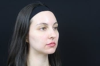 Woman with long hair and headband profile shot.