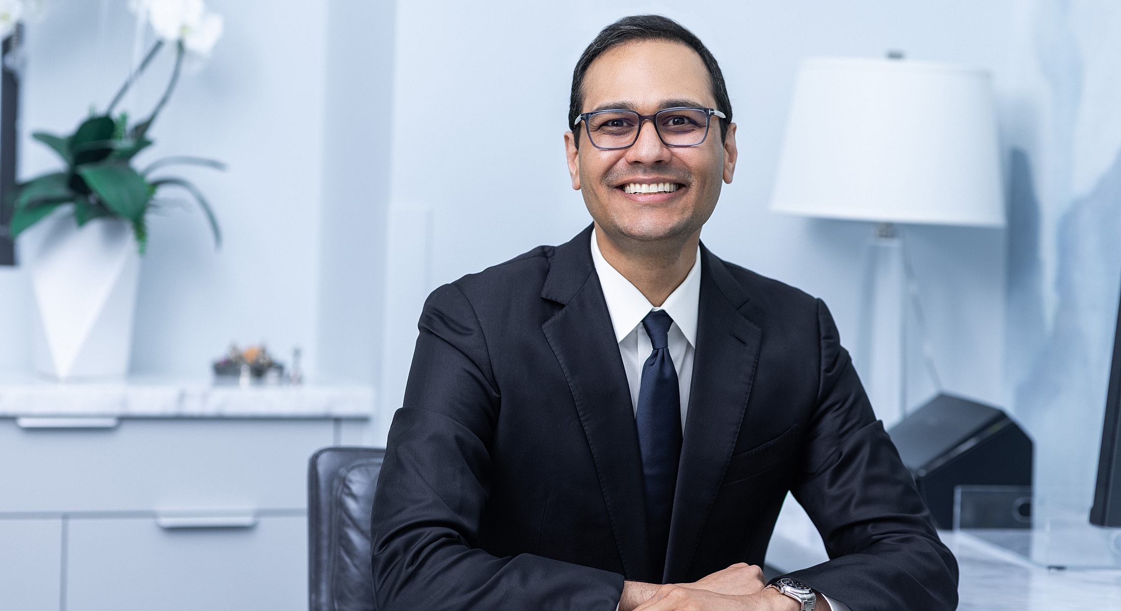 Business professional smiling in modern office.