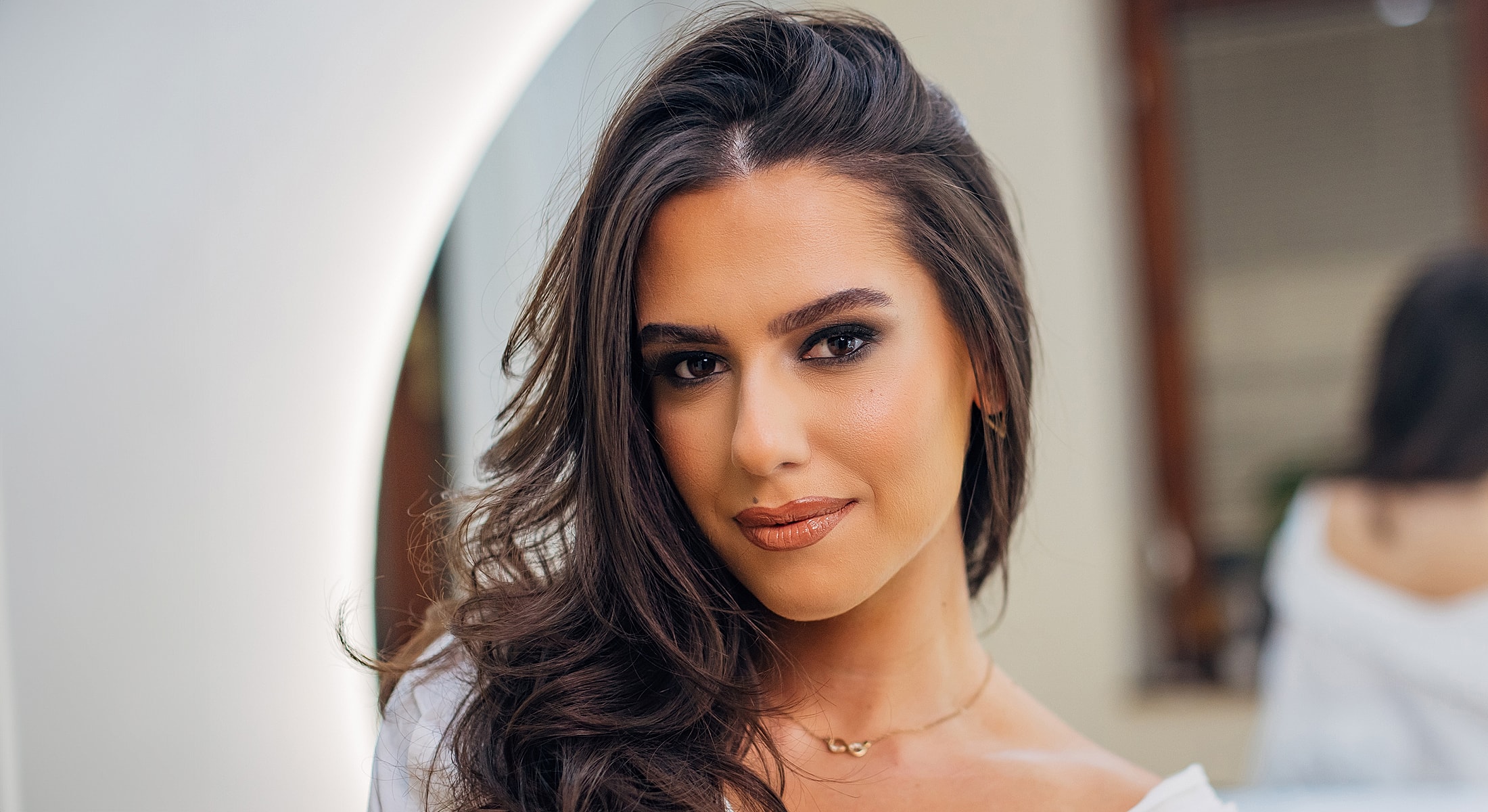 Woman with long hair and natural makeup.