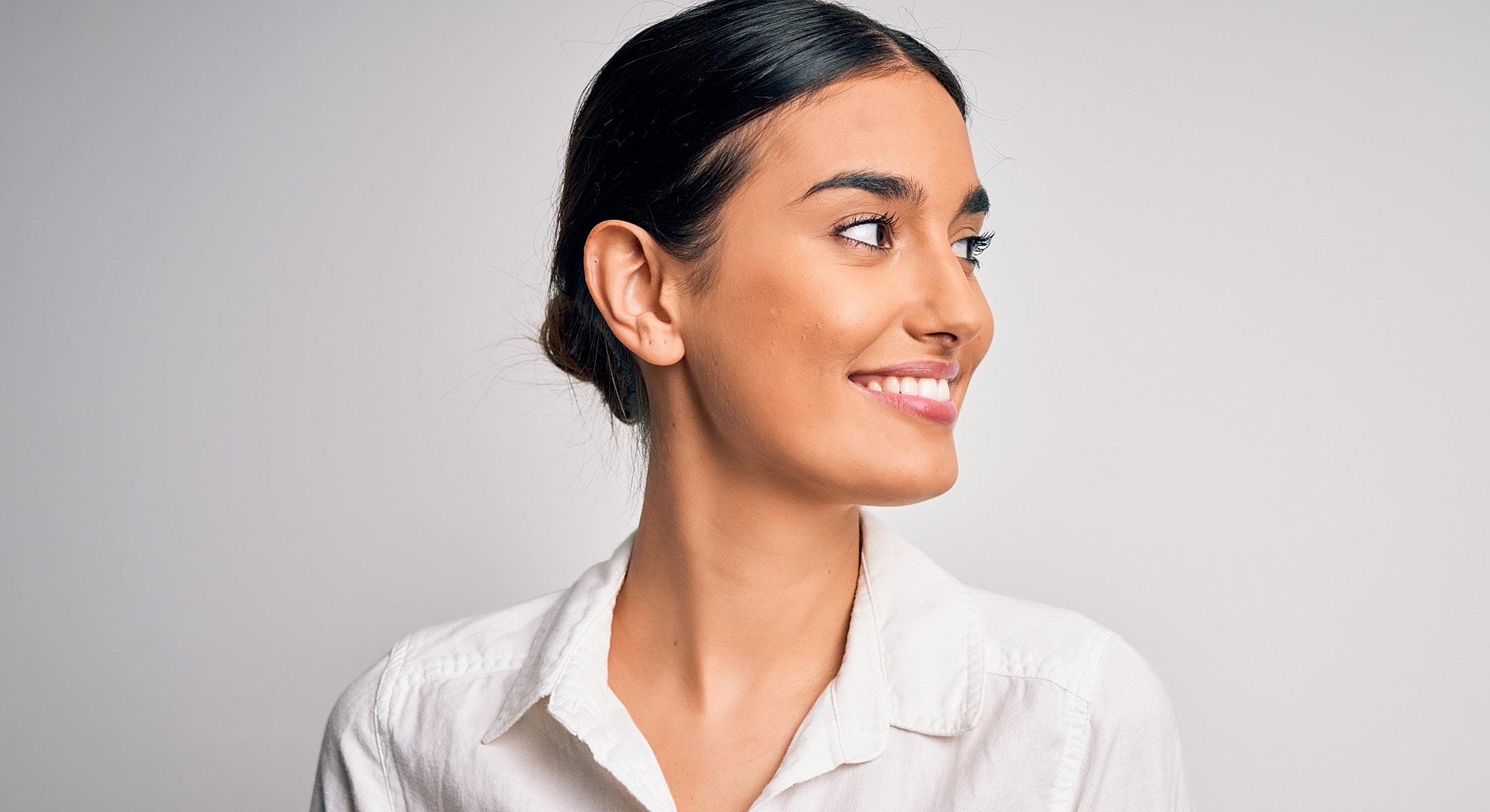 Miami Rosacea Treatment patient looking to the side, neutral background.