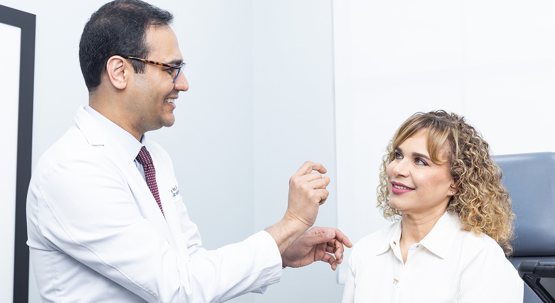 Doctor consulting with patient in medical setting.
